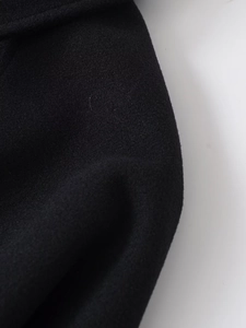 Macro shot of high-quality black wool blend fabric texture for casual zip jackets