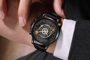 Close-up of black leather strap watch with gold accents and crocodile texture on wrist