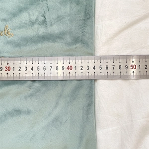 Close-up of velvet throw pillow cover measuring 43.5cm with gold embroidered detail
