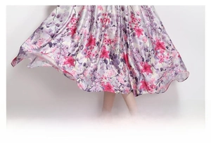 Detail of loose floral print satin skirt hem with elegant drape and purple flower patterns
