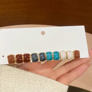 Minimalist gold hair clip with colorful rectangular enamel inlays for daily wear