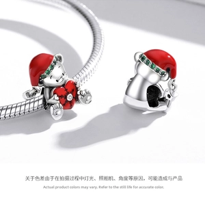Macro view of S925 sterling silver Christmas bear charm with red enamel heart detail