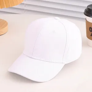 Minimalist white cotton baseball cap displayed in a cozy, bright lifestyle setting