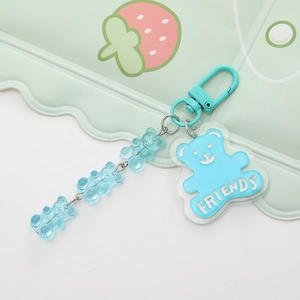 Detail of blue acrylic bear keychain with FRIENDS text and small beads on metal clasp