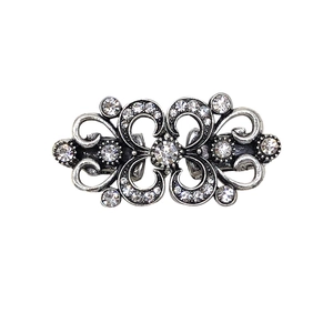 Vintage silver rhinestone butterfly sweater clip with crystal inlay on white background