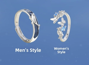 Detailed view of silver whale and butterfly couple rings with blue enamel and gemstones