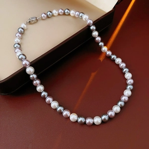 Detailed view of multi-color pearls in white and grey on a premium leather surface