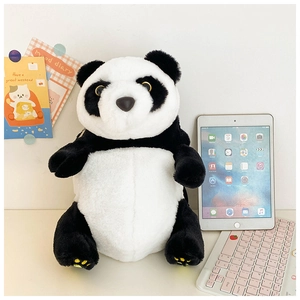 Detailed view of a plush panda backpack showing soft faux fur texture in a cozy room setting