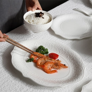 White relief ceramic tableware set with elegant embossed bowl and dinner plates