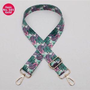 Detail of adjustable polyester strap with tropical leaf print and gold hardware
