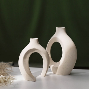 Nordic minimalist white ceramic vases in abstract U-shape and hollow circular geometry