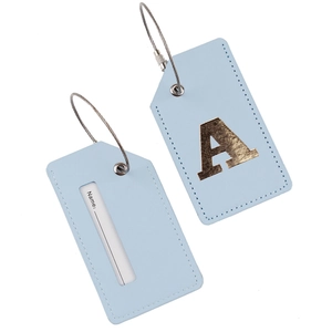 Detail of light blue PU leather luggage tags with gold letter A and steel wire loop