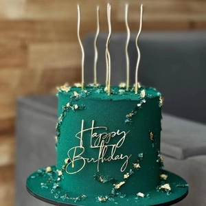 Dark green velvet cake with gold leaf flakes and gold Happy Birthday acrylic topper