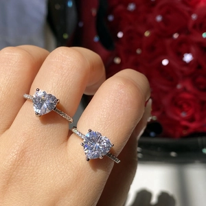 Detail shot of heart-cut pink cubic zirconia rings with silver band and micro-pave setting