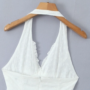 White halter neck dress with V-neckline and intricate hollow embroidery patterns