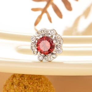 Titanium steel stud earring with a red round gemstone and sparkling clear accents