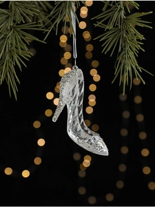 Macro detail of acrylic glass high heel ornament with silver glitter on Christmas tree branch