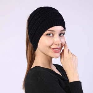 Detailed view of the black ribbed knit texture on a wide ponytail headband for winter