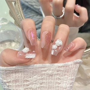 Macro detail of pink camellia floral press-on nails with 3D roses and pearls