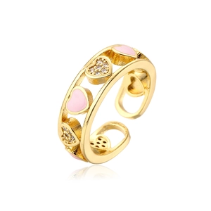 Close-up of gold-plated heart ring with pink enamel and micro-set zirconia stones