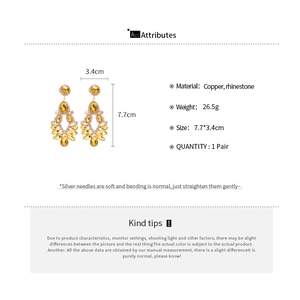 Detailed view of yellow rhinestone tassel earrings with copper material specs and 7.7cm size