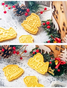 Detailed view of Christmas themed plastic cookie cutters with truck and house shapes