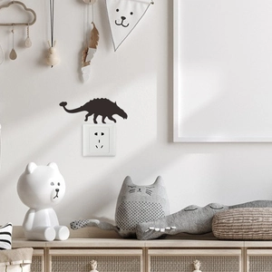 Black dinosaur silhouette light switch wall decal for a modern minimalist nursery room décor