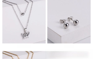 Close-up of double-layer necklace with hollow butterfly pendant and round bead stud earrings