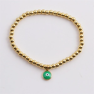 Minimalist gold beaded bracelet with green enamel evil eye pendant charm for women
