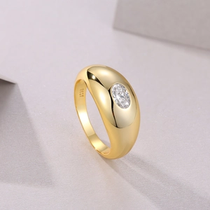 Macro detail of S925 engraved gold ring featuring an oval-cut moissanite stone