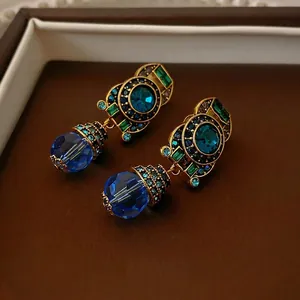 Vintage gold drop earrings with blue crystal and colorful rhinestones in retro style