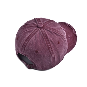 Distressed burgundy washed cotton baseball cap with ripped edges and metal buckle back