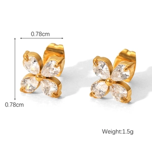 Macro shot of 0.78cm golden four-petal flower stud earrings with white cubic zirconia