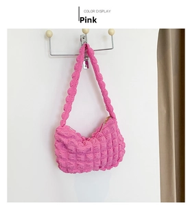 Pink popcorn texture shoulder bag with metallic zipper and fabric strap detail