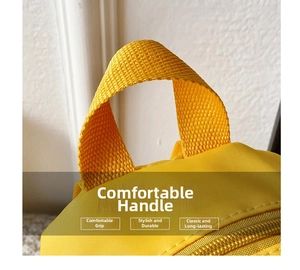 Close-up of durable nylon handle and smooth yellow zipper on cartoon duck backpack
