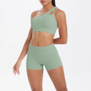 Detail of sage green one-shoulder sports bra and high-waist shorts set for gym