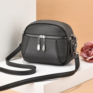Minimalist grey PU leather crossbody bag with multiple zipper compartments and shoulder strap