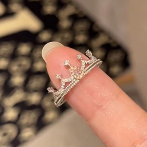 Macro shot of a luxury silver crown ring with sparkling pink heart stone and white zircon