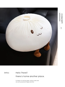 Detail of creative bun plush pillow with embroidered face on a black leather sofa
