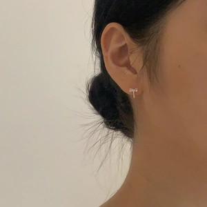 Elegant 925 sterling silver bow knot earrings with cubic zirconia stones on model