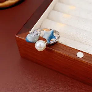 Nautical starfish and pearl open ring with blue enamel sea elements in a jewelry box