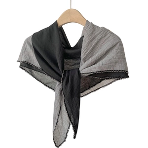 Elegant black and grey patchwork cotton linen scarf with delicate lace trim on a hanger