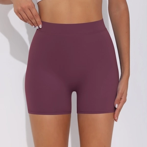 Detail of high waist seamless yoga shorts in deep purple with wide waistband compression
