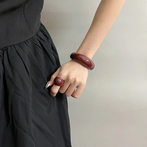 Minimalist burgundy resin jewelry set featuring a chunky ring and glossy arched bracelet