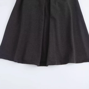 Elegant black A-line wool skirt with a smooth drape and sophisticated pleat details