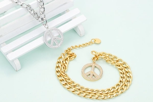 Detailed macro view of gold and silver peace sign pendants with white zircon stones
