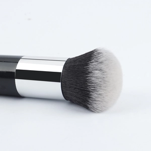 Detailed macro view of dense synthetic bristles and silver ferrule on foundation brush