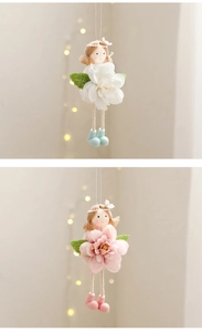 Detailed view of hanging fabric spring dolls with colorful flower dresses for Easter decor