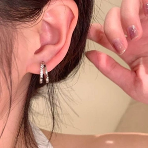 Elegant silver double-hoop zircon earrings for women worn by a model on a soft background
