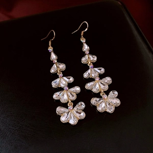 Macro detail of elegant gold-tone tassel earrings with sparkling rhinestones for women